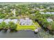 Overhead aerial view shows the apartment complex surrounded by lush trees and a lake at 4141 Dolphin Dr # 4141, Tampa, FL 33617