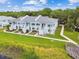 Aerial view shows the apartment complex overlooking the lake with mature trees and landscaping at 4141 Dolphin Dr # 4141, Tampa, FL 33617