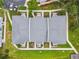 Top-down aerial view of the complex with a gray roof, mature landscaping, and paved walkways at 4141 Dolphin Dr # 4141, Tampa, FL 33617