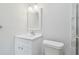 Bright bathroom features white vanity, framed mirror and white toilet at 4141 Dolphin Dr # 4141, Tampa, FL 33617