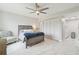 Bright bedroom featuring a modern ceiling fan, spacious closet, and contemporary furniture on marble-look flooring at 4141 Dolphin Dr # 4141, Tampa, FL 33617