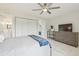 Light-filled bedroom has a TV, well-organized closet, and an en-suite bathroom, all on marble style floors at 4141 Dolphin Dr # 4141, Tampa, FL 33617