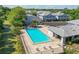 Aerial view of community pool surrounded by lush landscaping and residential buildings at 4141 Dolphin Dr # 4141, Tampa, FL 33617