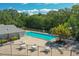 Community pool area with lounge chairs and tables at 4141 Dolphin Dr # 4141, Tampa, FL 33617