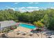 Aerial view of community pool area with lounge chairs, tables, and lush landscaping at 4141 Dolphin Dr # 4141, Tampa, FL 33617