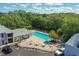 Community pool area with lounge chairs, tables, and lush landscaping at 4141 Dolphin Dr # 4141, Tampa, FL 33617