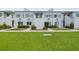 Two-story condo building featuring a well-maintained lawn and simple, clean architectural details at 4141 Dolphin Dr # 4141, Tampa, FL 33617