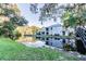 Back of home nestled on a scenic lake, with a lovely bridge and lush landscaping at 4141 Dolphin Dr # 4141, Tampa, FL 33617