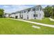 Exterior view of a condo building with a lush green lawn, showcasing its curb appeal at 4141 Dolphin Dr # 4141, Tampa, FL 33617