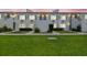 A charming two-story condo building in a residential area shown at dusk with manicured lawn and shrubbery at 4141 Dolphin Dr # 4141, Tampa, FL 33617