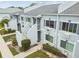 Aerial view of the condo buildings with light blue exterior and white trim at 4141 Dolphin Dr # 4141, Tampa, FL 33617