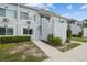 Front view of a two-story condo, set in a well-maintained lawn with path leading to entrance at 4141 Dolphin Dr # 4141, Tampa, FL 33617