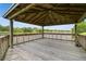 Interior view of a wooden gazebo, providing shade and a panoramic view of the serene lake at 4141 Dolphin Dr # 4141, Tampa, FL 33617