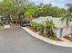 Exterior view of home with screened-in hot tub, attractive landscaping, and well-maintained driveway at 4141 Dolphin Dr # 4141, Tampa, FL 33617