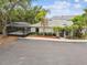 Exterior view of home with screened-in hot tub and attractive landscaping at 4141 Dolphin Dr # 4141, Tampa, FL 33617