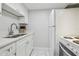 Well-lit kitchen features white cabinets, stainless steel sink and appliances at 4141 Dolphin Dr # 4141, Tampa, FL 33617