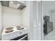 This kitchen features an electric stove top and stainless steel range hood at 4141 Dolphin Dr # 4141, Tampa, FL 33617