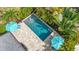 Aerial view showcases the pool, travertine patio, and lush tropical landscaping at 4231 8Th N St, St Petersburg, FL 33703