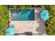 Aerial view showcases the pool, travertine patio, and lush tropical landscaping at 4231 8Th N St, St Petersburg, FL 33703