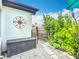 Backyard with decorative compass, storage box, rock garden, and lush landscaping at 4231 8Th N St, St Petersburg, FL 33703