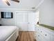 Bright bedroom with hardwood floors, white furnishings and a ceiling fan at 4231 8Th N St, St Petersburg, FL 33703
