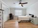 Well-lit bedroom with hardwood floors, a ceiling fan, and built-in closet at 4231 8Th N St, St Petersburg, FL 33703