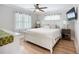 Bright bedroom with white furnishings, hardwood floors and a ceiling fan at 4231 8Th N St, St Petersburg, FL 33703