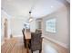 Elegant dining room with a wooden table and stylish wicker chairs under a modern light fixture at 4231 8Th N St, St Petersburg, FL 33703