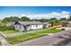 Charming single-story home with a white picket fence and well-manicured lawn under a bright blue sky at 4231 8Th N St, St Petersburg, FL 33703