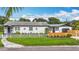 Charming home with white picket fence, flowering plants, and landscaped front yard at 4231 8Th N St, St Petersburg, FL 33703