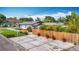 Charming home with a privacy fence, red potted plants, and concrete driveway at 4231 8Th N St, St Petersburg, FL 33703