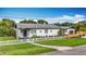 Charming home with white picket fence, flowering plants, and landscaped front yard at 4231 8Th N St, St Petersburg, FL 33703
