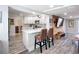 Bright open-concept kitchen with a breakfast bar, white cabinets, and views into the living room at 4231 8Th N St, St Petersburg, FL 33703