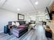 Spacious living room with a large sectional, wood look flooring and modern decor at 4231 8Th N St, St Petersburg, FL 33703