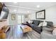 Living room with a large grey sectional, french doors, wood-look floors and wood accent wall at 4231 8Th N St, St Petersburg, FL 33703