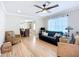 Open-concept living room with hardwood floors, comfortable seating, and seamless flow into the dining area at 4231 8Th N St, St Petersburg, FL 33703