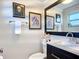 Elegant powder room with a stylish mirror and artwork at 4231 8Th N St, St Petersburg, FL 33703