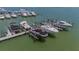 Aerial view of boat docks with lifts, showcasing waterfront living at 425 150Th Ave # 2301, Madeira Beach, FL 33708