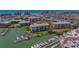 Aerial view of condo building with boat docks, lush green surroundings, and proximity to the ocean at 425 150Th Ave # 2301, Madeira Beach, FL 33708