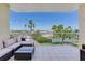 Spacious tiled balcony with comfortable seating and picturesque views of the waterfront at 425 150Th Ave # 2301, Madeira Beach, FL 33708