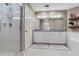 Well-lit bathroom featuring a double vanity with granite countertops, walk-in shower and soaking tub at 425 150Th Ave # 2301, Madeira Beach, FL 33708