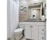 Cozy bathroom featuring white cabinets, granite countertop and a shower with a white shower curtain at 425 150Th Ave # 2301, Madeira Beach, FL 33708