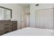 Bright bedroom with sleek dresser, plush carpeting, and spacious closet for ample storage at 425 150Th Ave # 2301, Madeira Beach, FL 33708