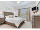 Bright bedroom with light walls, a large window, and a wicker headboard at 425 150Th Ave # 2301, Madeira Beach, FL 33708