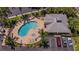 Aerial view of the community pool and lounge area, surrounded by landscaping and convenient parking at 425 150Th Ave # 2301, Madeira Beach, FL 33708