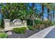 Sign for Snug Harbour community, with well-maintained landscaping and a welcoming entrance at 425 150Th Ave # 2301, Madeira Beach, FL 33708