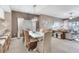 Elegant dining area with woven chairs, a white table, and comfortable living space beyond at 425 150Th Ave # 2301, Madeira Beach, FL 33708