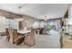 Bright dining area with seating for six, flowing into a comfortable living room with balcony access at 425 150Th Ave # 2301, Madeira Beach, FL 33708