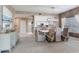 Dining area with a modern table, stylish chairs, and an open view of the kitchen at 425 150Th Ave # 2301, Madeira Beach, FL 33708