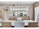 Dining area with modern lighting, wicker chairs, and open access to the kitchen at 425 150Th Ave # 2301, Madeira Beach, FL 33708